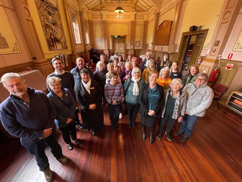 A large group of volunteers stand in Beechworth Town Hall