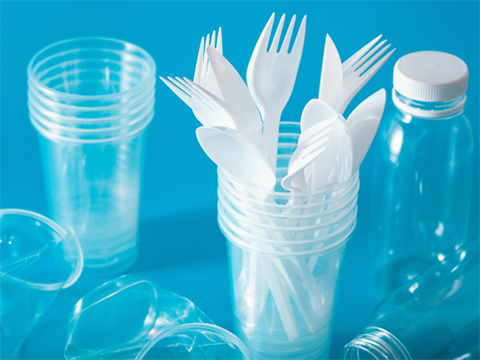 Blue background with collection of plastic cups, containers and cutlery